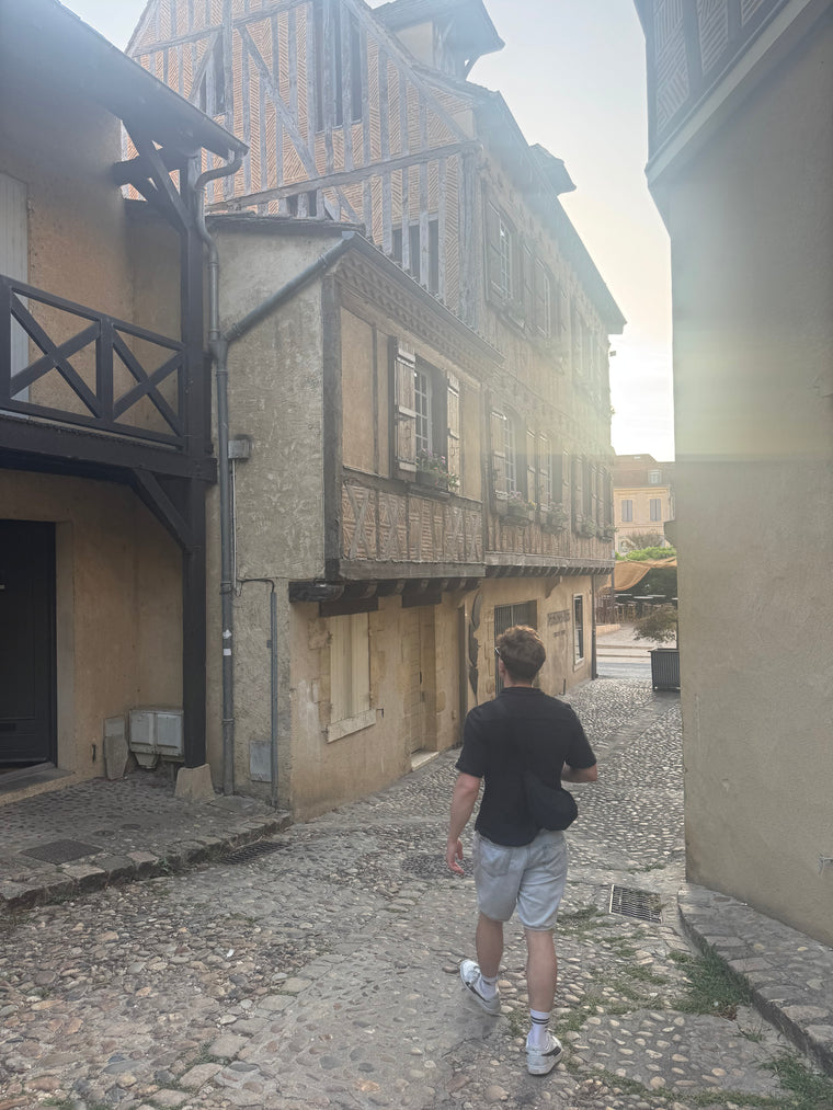 Kieran exploring France walking down an old alleyway